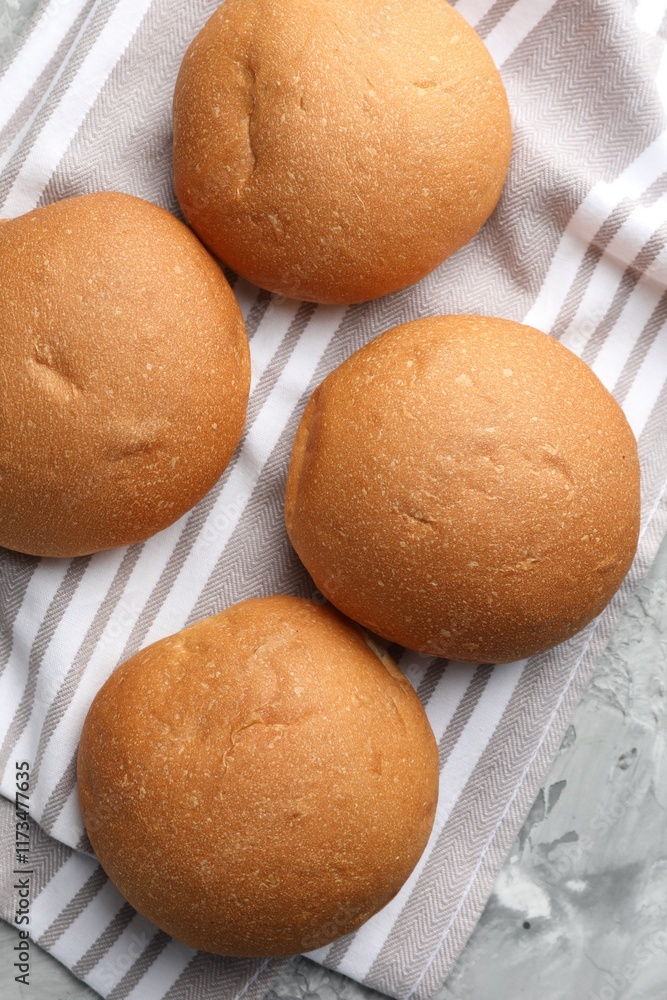 Fresh tasty buns on grey table, top view Fresh tasty buns on grey table, top view