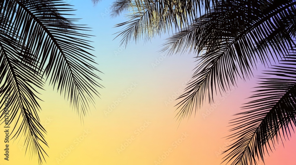 Fototapeta premium Silhouetted palm leaves against a colorful sunset sky