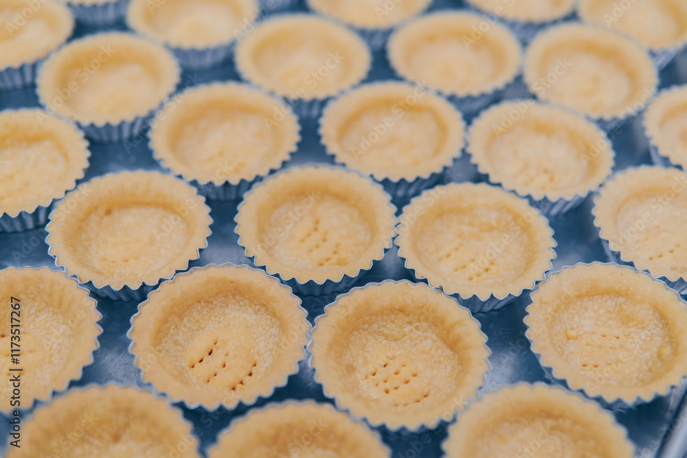 Close up top view of mini tartlet cups, empty unfilled pastry tartlet shell. Close up top view of mini tartlet cups, empty unfilled pastry tartlet shell.