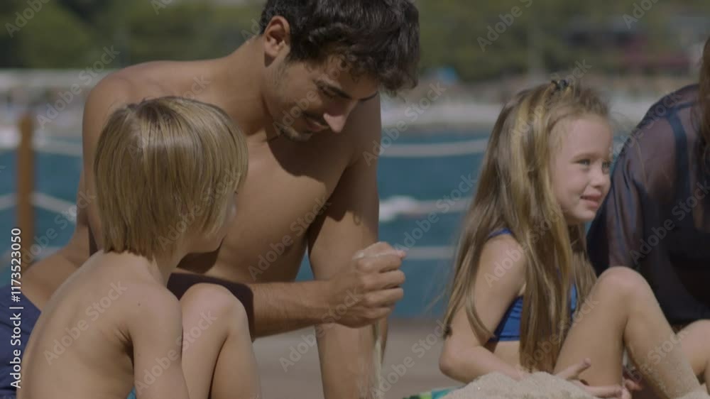 Young family, mother, father and two children having fun on the beach. Happy family with a girl and a boy, having a great time on a summer vacation, playing in the sand. Vacation and family concept Young family, mother, father and two children having fun on the beach. Happy family with a girl and a boy, having a great time on a summer vacation, playing in the sand. Vacation and family concept