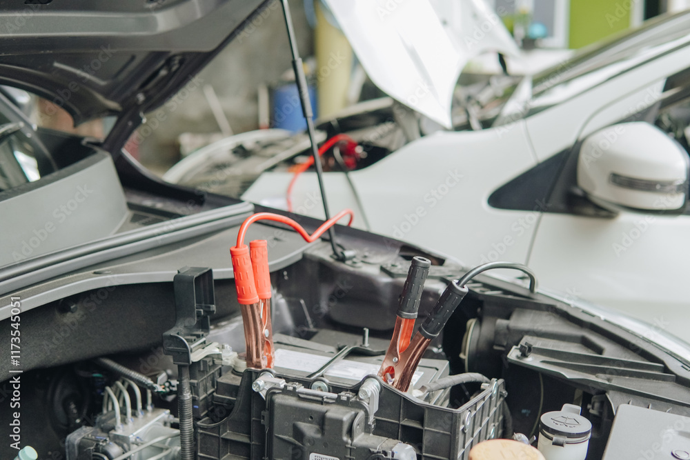 Charging automobile discharged battery by booster jumper cables. Charging automobile discharged battery by booster jumper cables.
