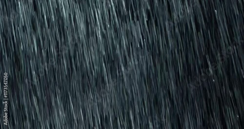 4K high-speed angled heavy rainstorm on a black surface, dynamic splashing of raindrops. High-end rain closeup VFX insert, a powerful weather element, showcasing the intense realism of the rain. 