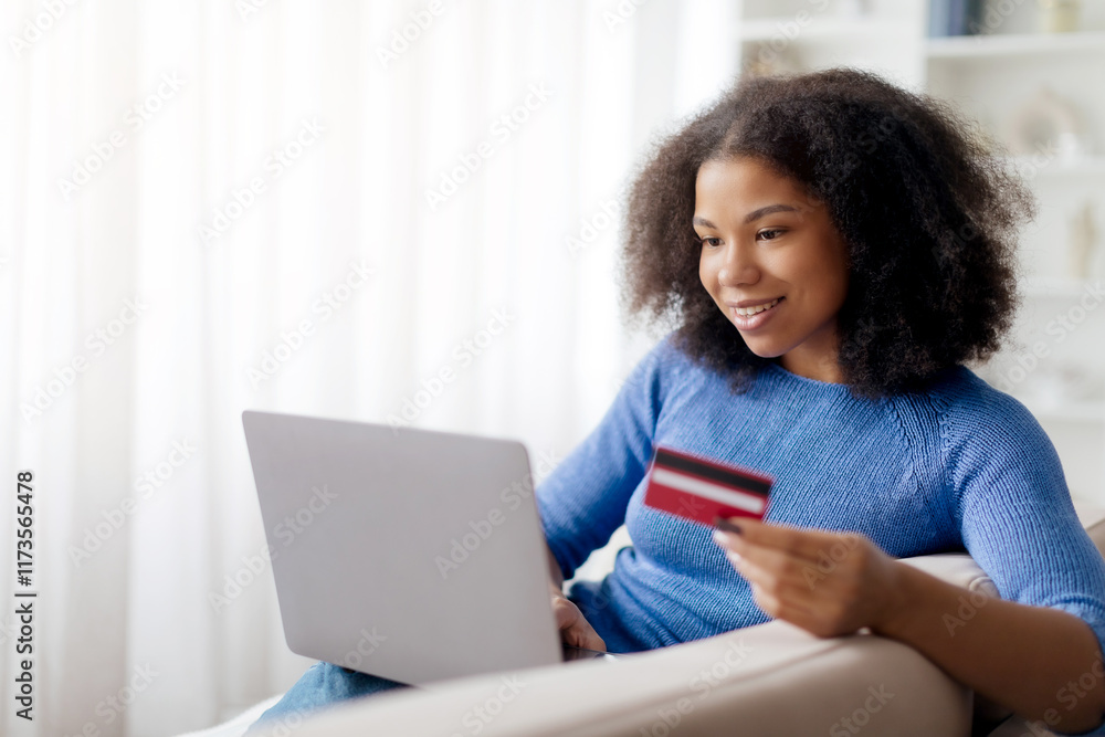 Online Shopping. Happy Black Woman Using Pc Laptop And Credit Card Making Payment Using Internet Banking Sitting On Sofa At Home. Female Customer Paying With Bankcard Ordering Delivery On Website Online Shopping. Happy Black Woman Using Pc Laptop And Credit Card Making Payment Using Internet Banking Sitting On Sofa At Home. Female Customer Paying With Bankcard Ordering Delivery On Website
