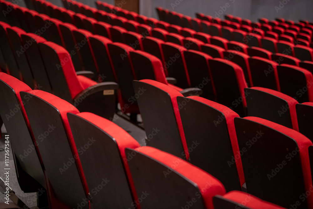 Naklejka premium Rows of luxurious, expensive, red chairs of classical design in the auditorium of classical academic theatre.