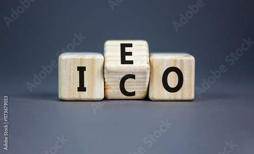 Initial coin or exchange offering symbol. Concept words abbreviation ICO or IEO on wooden block. Beautiful grey table grey background. Business Initial coin or exchange offering concept. Copy space. photo