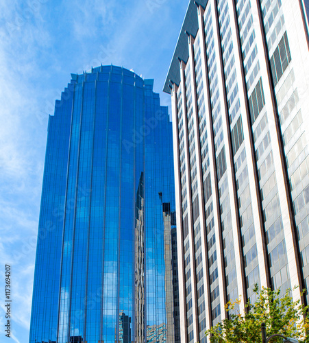 Beautiful skyscrapers reflect othe tall buildings on a clear day photo