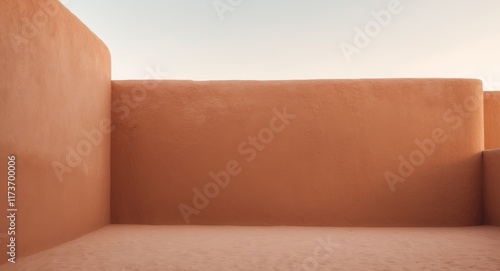 Smooth adobe wall in warm terracotta color with matte finish photo