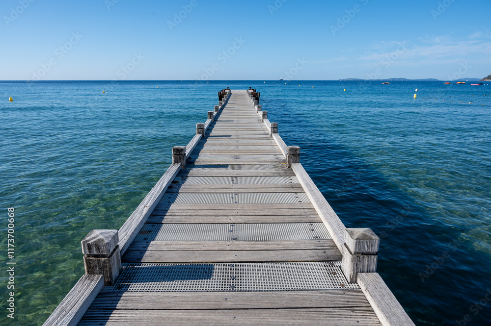 Fototapeta premium Morning view on crystal clear blue water of Plage du Debarquement white sandy beach near Cavalaire-sur-Mer and La Croix-Valmer, summer vacation on French Riviera, Var, France