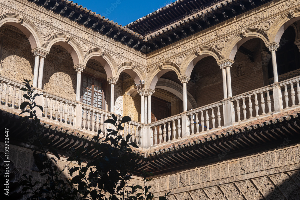 Fototapeta premium Walls of palace in historical Andalusian town Seville, Spain. View on houses, architectural details of buidings. Summer in Andalusia.