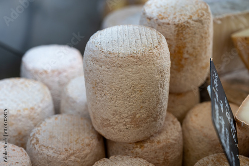 Weekly farmers market in Sarlat-la-Caneda, Dordogne, french cheeses from farm, small goat cheese tommette from Pyrenees photo