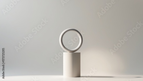 Elegant White Decor with Ring on Cylindrical Stand and Soft Background photo