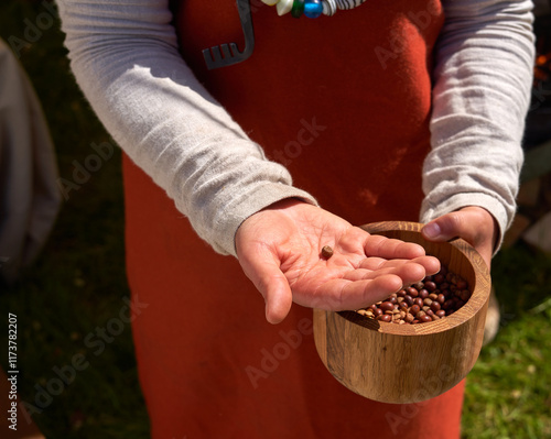 Woman holding out a solitary seed photo