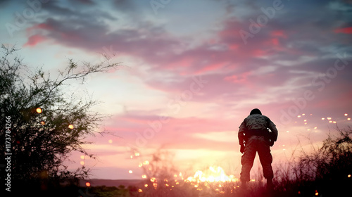 Soldier sunset silhouette, desert landscape, peaceful contemplation, war veteran reflection, stock photo. photo