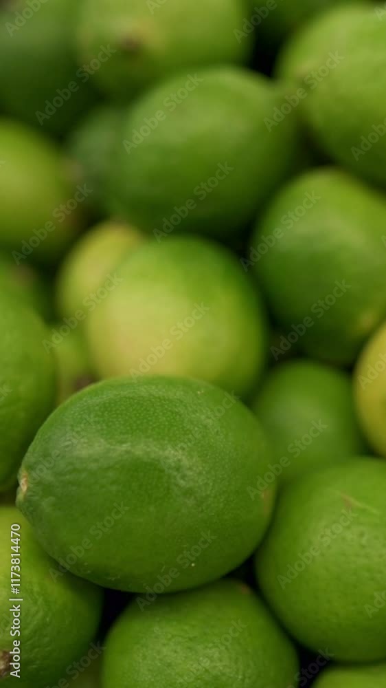 Vertical screen: Fresh Green Limes Close-Up vibrant fresh green limes, showcasing their textured skin and natural, healthy appearance, citrus, fresh, limes, sour, healthy, organic Vertical screen: Fresh Green Limes Close-Up vibrant fresh green limes, showcasing their textured skin and natural, healthy appearance, citrus, fresh, limes, sour, healthy, organic