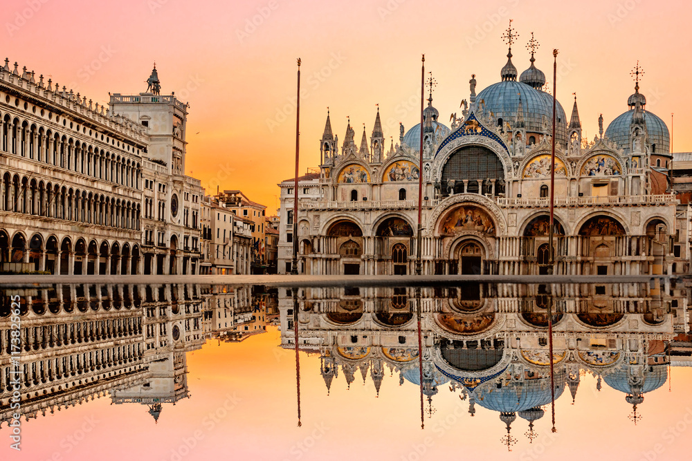 June 25, 2019. Venice, Italy. Sunrise in San Marco square with Campanile and San Marco's Basilica. The main square of the old town. Venice, Veneto Italy. Reflection on the flooded square.