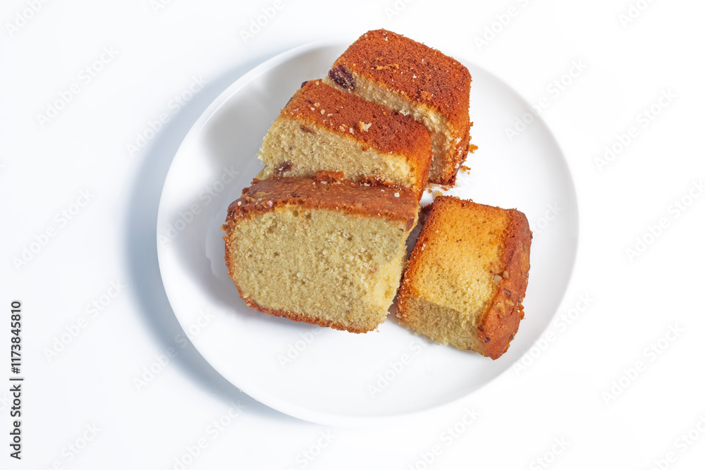 Four slices of freshly baked sponge cake on a white plate, top view Four slices of freshly baked sponge cake on a white plate, top view