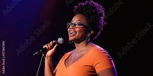 black female stand-up comedian telling joke on stage - photo