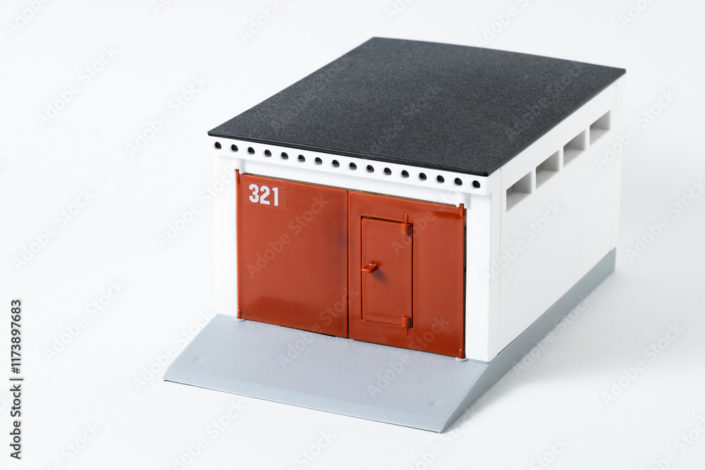 Miniature garage that stands out against white background. Concept dreams and real estate. Miniature garage that stands out against white background. Concept dreams and real estate.