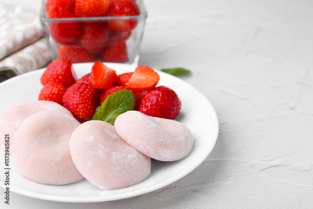 Delicious mochi and strawberries on white table, closeup Delicious mochi and strawberries on white table, closeup