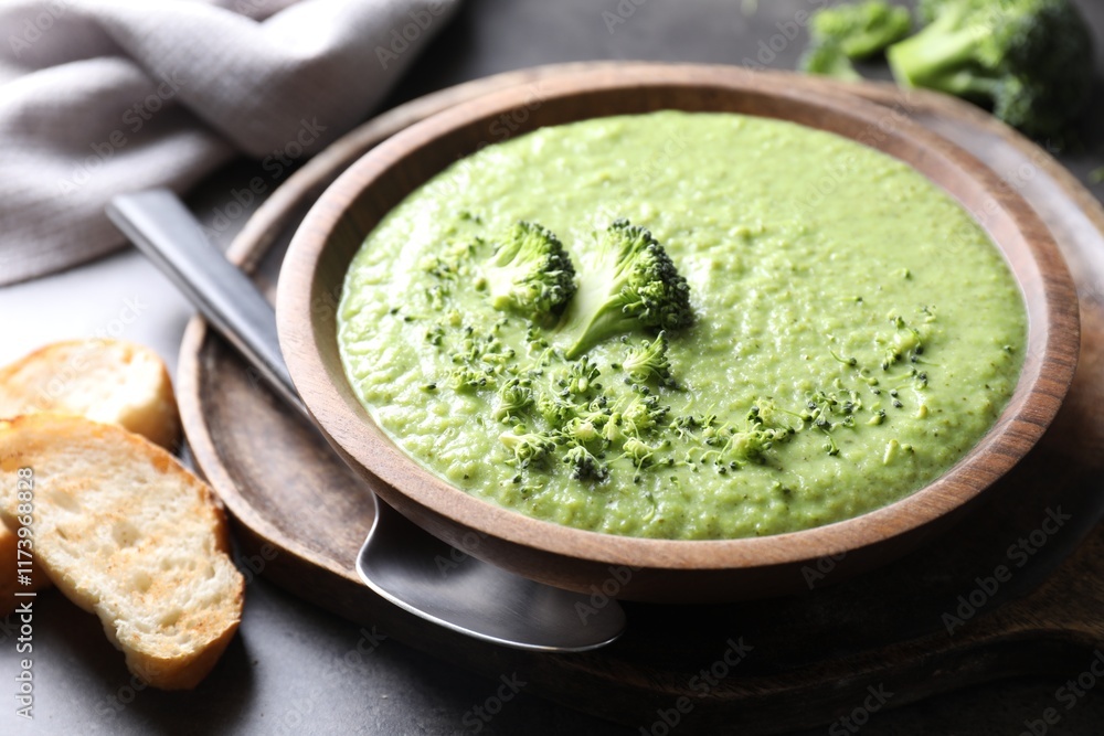 Delicious broccoli cream soup served on grey table, closeup Delicious broccoli cream soup served on grey table, closeup