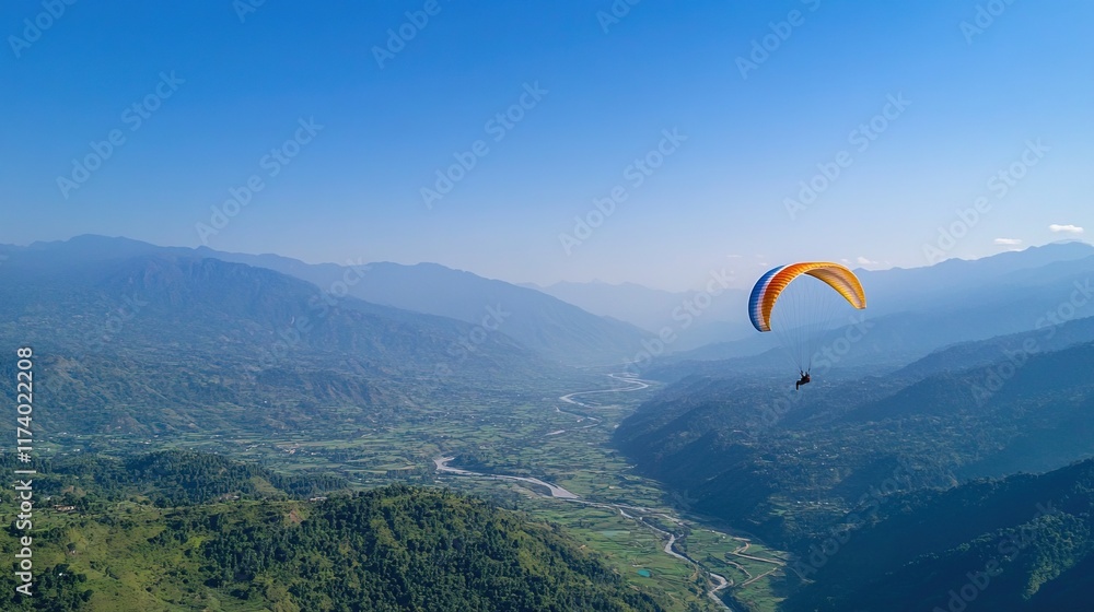 Paraglider soars over valley with clear blue skies and mountain ranges. Paraglider soars over valley with clear blue skies and mountain ranges.