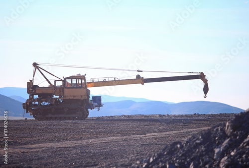 A crane loading rock at a mining site