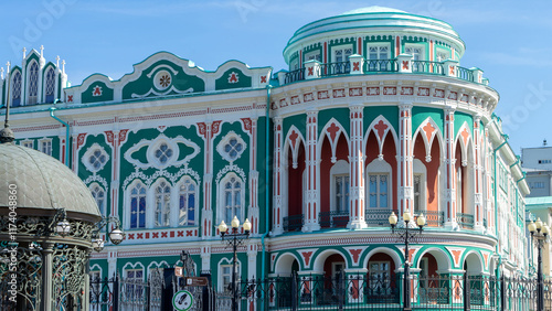 Sevastyanov's House or House of Trade Unions on shore of city pond formed by dam on Iset River. Historical and architectural monument located in Yekaterinburg, Russia photo