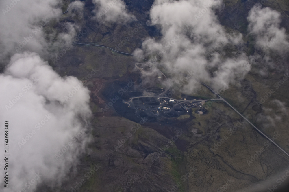 Fototapeta premium Iceland from airplane through clouds. Aerial scenic view of Iceland landscape. Travel vacation concept. Europe.