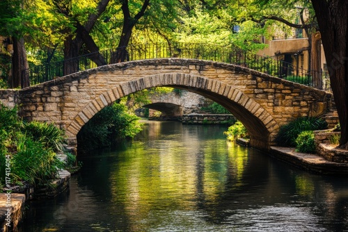 Stone arch bridge crossing the san antonio riverwalk in texas photo