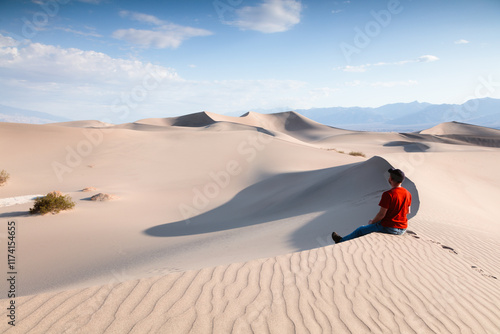 Man on a sand dune at Mesquite Flat Sand Dunes, Death valley National Park, California, United States photo