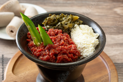 A view of a bowl of kitfo, with some injera. photo