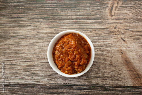 A top down view of a condiment cup of misir wat. photo