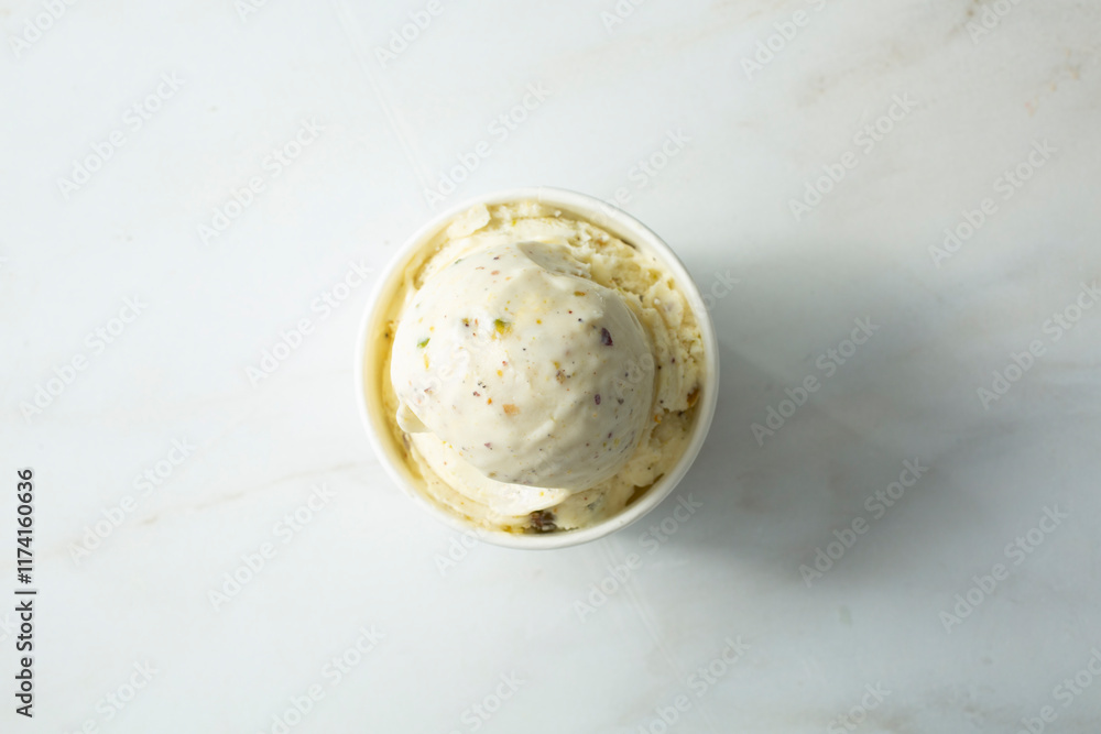 A top down view of a scoop of saffron pistachio ice cream. A top down view of a scoop of saffron pistachio ice cream.