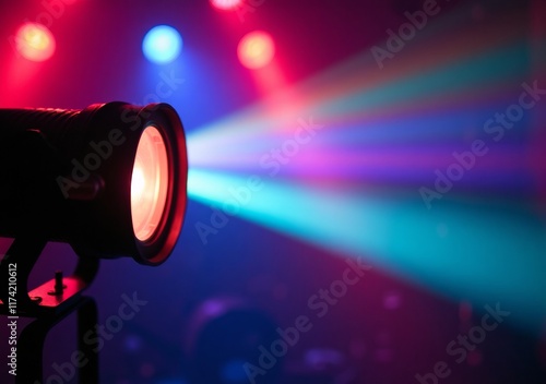 Bright stage lights create colorful beams at a live music event in the evening