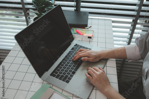 businesswoman working on laptop in her studio, businessperson working on a digital tablet and laptop in an office, busy professional executive leader working on business finances analysis