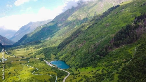 Aerial drone view of mountain landscape glaciers and valley on a sunny day. Dombay, North Caucasus, Karachay-Cherkessia. High quality 4k footage