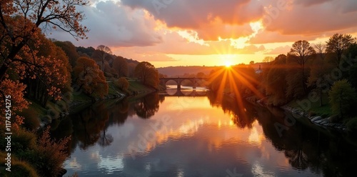 Warm golden light fades over river Calder at dusk, west yorkshire, golden hues, evening sky photo