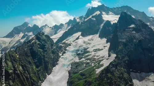 Aerial drone view of mountain landscape glaciers and valley on a sunny day. Dombay, North Caucasus, Karachay-Cherkessia. High quality 4k footage