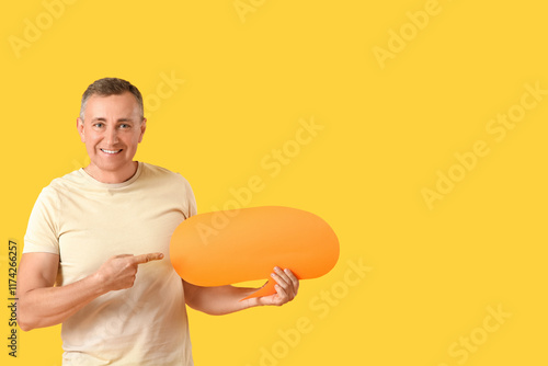 Mature man pointing at blan...