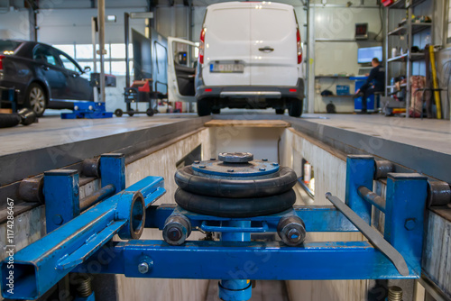 A car leaves the inspection line at the technical inspection station. Technical inspection of the car in the workshop.