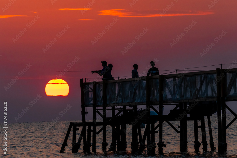 Obraz premium sunrise on beach with a trestle at Cervia Italy