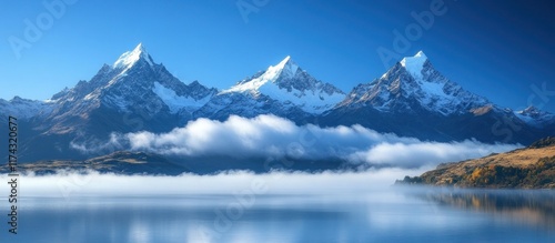 Wallpaper Mural Majestic snow-capped mountain peaks reflected in a calm lake with a layer of fog. Torontodigital.ca