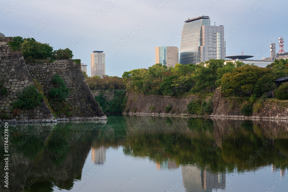 View of the inner moat and ramparts around Osaka Castle and the surrounding urban landscape on an early autumn morning, Osaka, Japan View of the inner moat and ramparts around Osaka Castle and the surrounding urban landscape on an early autumn morning, Osaka, Japan