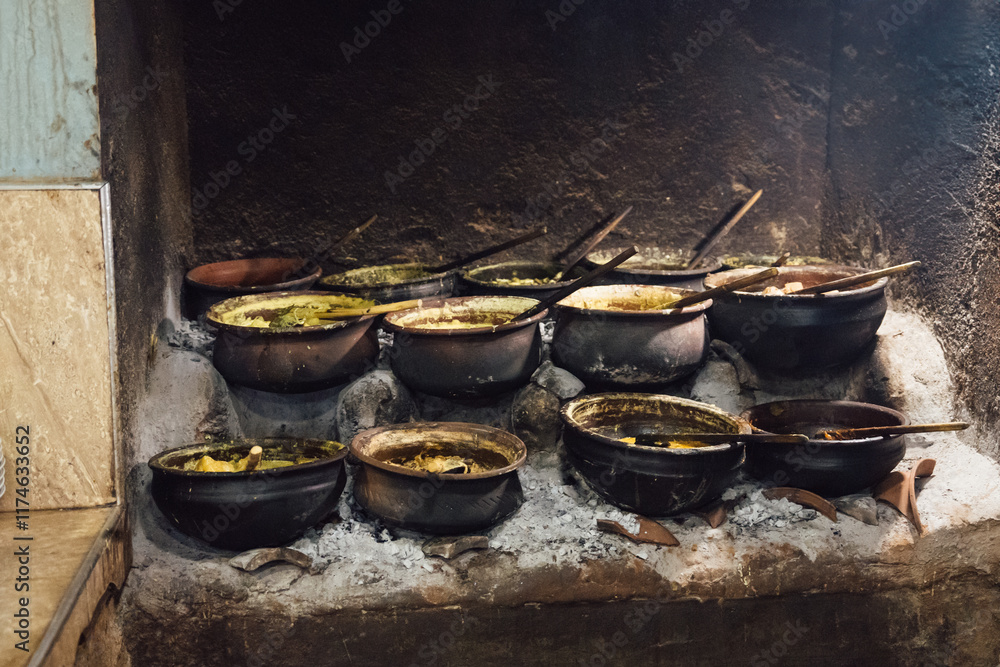 Traditional Sri Lankan clay cooking pots filled with curries Traditional Sri Lankan clay cooking pots filled with curries