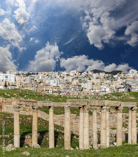 Roman Columns in the Jordanian city of Jerash (Gerasa of Antiquity), capital and largest city of Jerash Governorate, Jordan. Against the background of a beautiful sky with clouds #1174637452