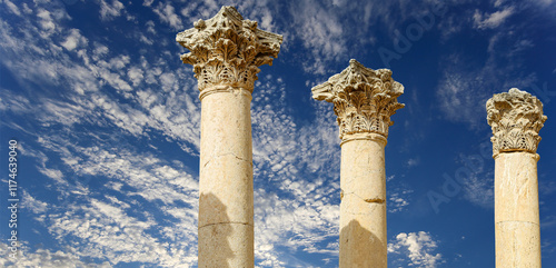 Roman Columns in the Jordanian city of Jerash (Gerasa of Antiquity), capital and largest city of Jerash Governorate, Jordan. Against the background of a beautiful sky with clouds #1174639040