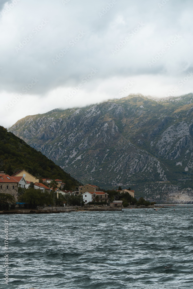 Fototapeta premium Rugged slopes and calm bay at golden hour
