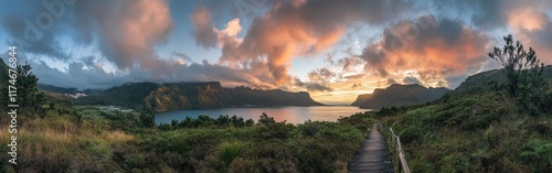 A panoramic view of an incredible vista on the Islands, featuring beautiful mountains and a lake with a wooden guardrail path leading to it at sunrise, set against a beautiful sky.
