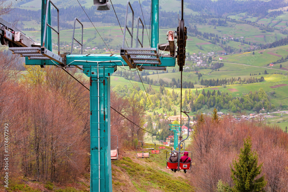 Exploration of tranquil hills while riding a cable car through lush greenery in springtime
