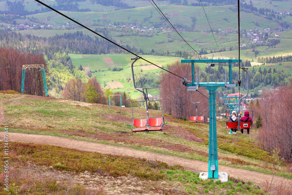 Scenic chairlift ride through vibrant hills on a peaceful spring afternoon